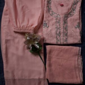 It’s Punjabi suit with plazo. Its color is peach. It’s party wear suit